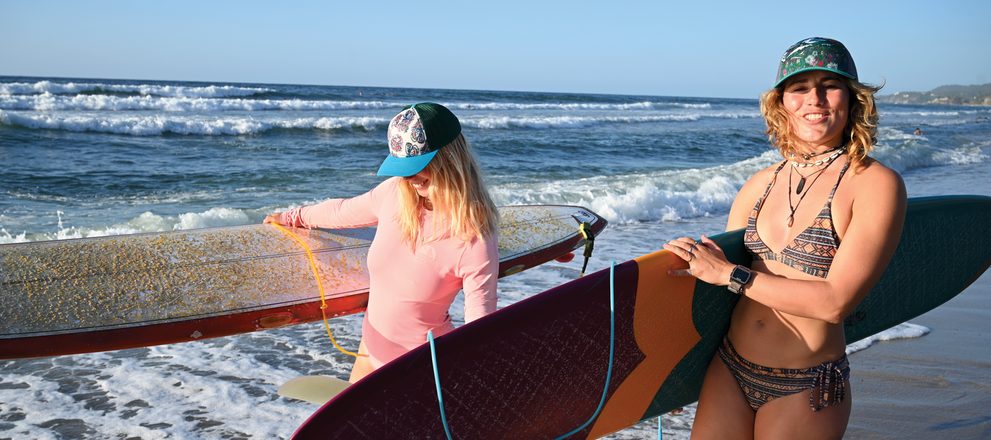 Women surfing hats wearing Katherine Homes artist trucker hats