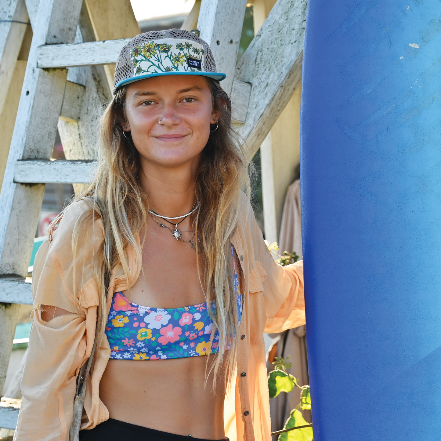 Katherine Homes Whorled Sunflower hat on model, mesh side cap, runner, outdoor adventure hat